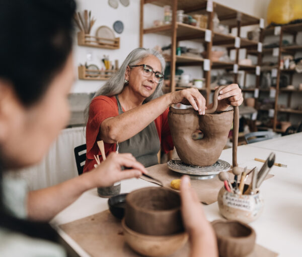 Senior woman making a craft product on a ceramics workshop